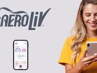 A woman happily looks at her phone with the Aeroliv app displayed.