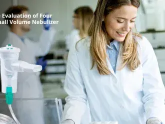 a woman in a lab coat smiles while coworkers stand in the background.