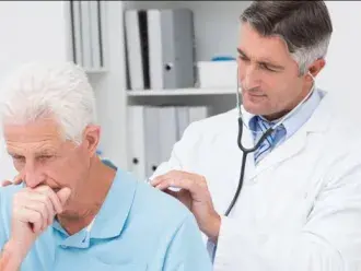 man coughing at the doctors office