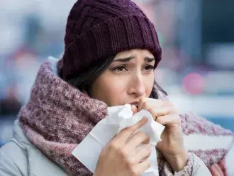 woman coughing in winter