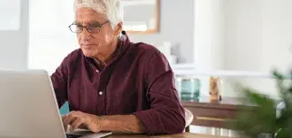 older man using laptop