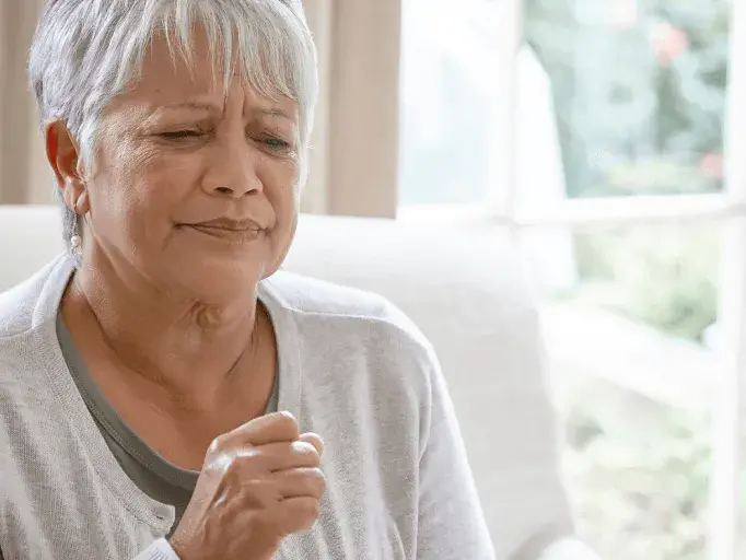 Elderly woman coughing