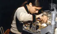 woman working on medical device in 1980