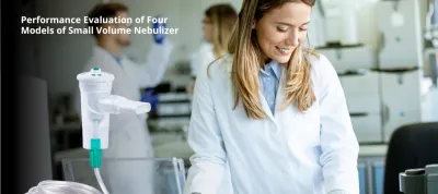 a woman in a lab coat smiles while coworkers stand in the background.