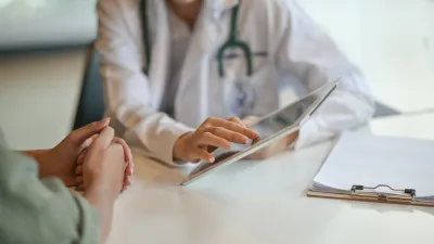 doctor showing patient something on ipad