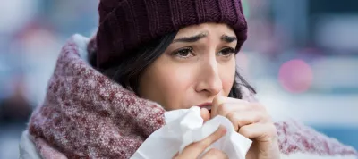 woman coughing in winter