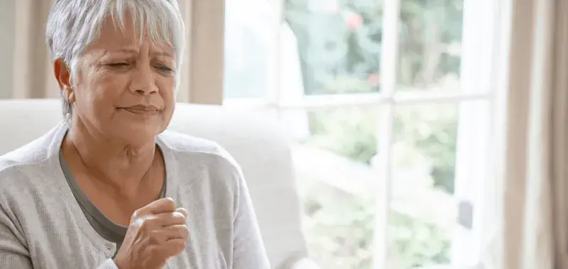 Elderly woman coughing