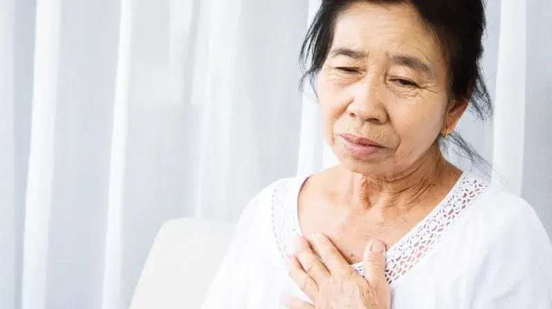 woman clutching chest