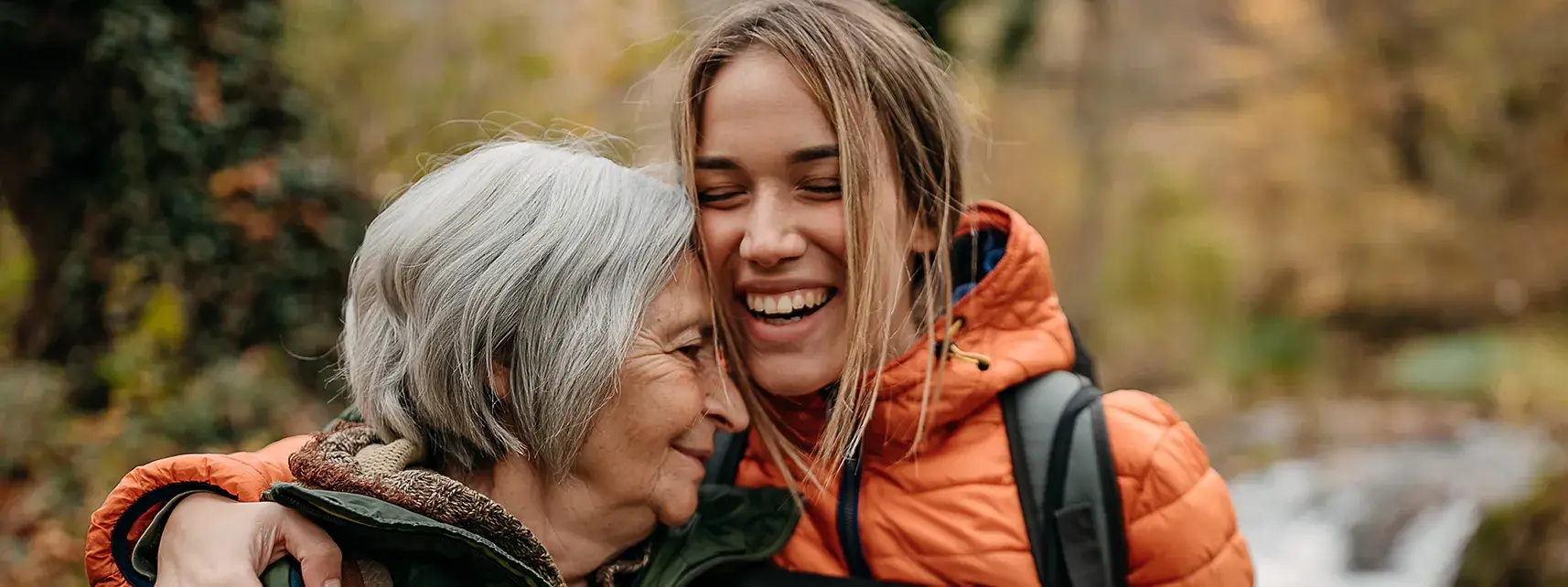 Woman embracing elderly woman with AeroChamber graphic