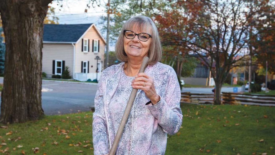 patty rake leaves in front of her house